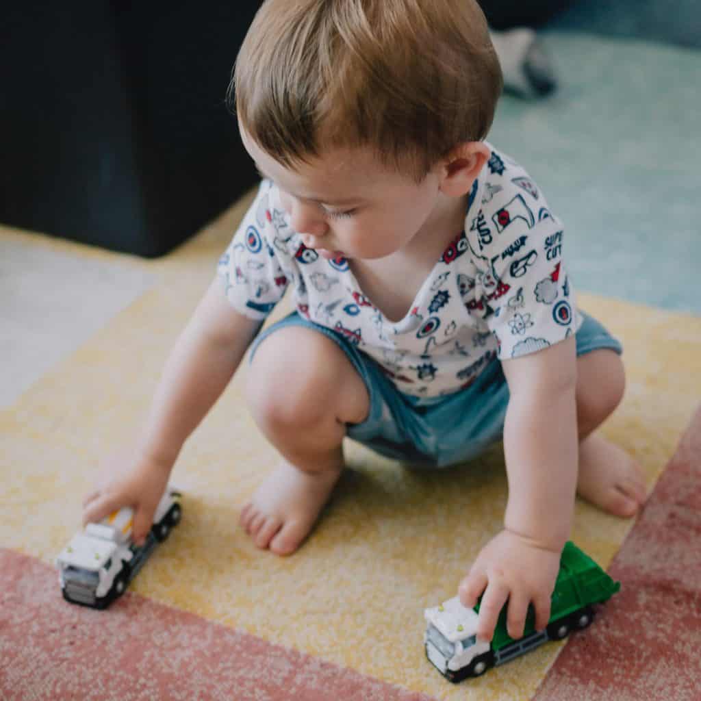 Child playing with toy trucks - different Early Years Learning Approaches including Reggio Emilia